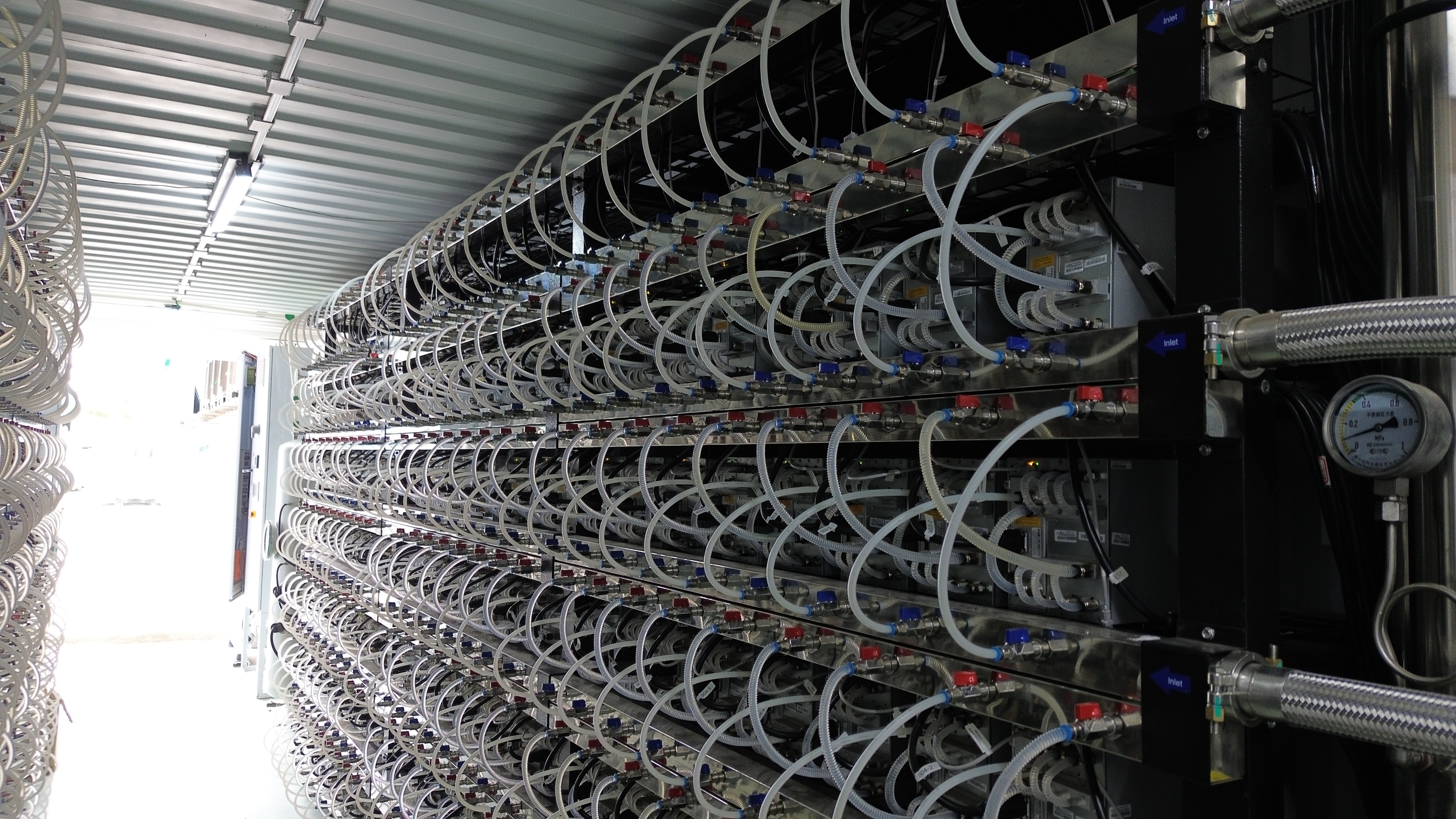 Supply and return manifolds, hoses and pressure gauge beside hydro miners